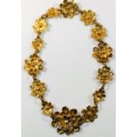 A Christian Lacroix, Paris, gilt metal necklace, comprised of 14 flower head links,