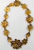 A Christian Lacroix, Paris, gilt metal necklace, comprised of 14 flower head links,