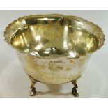 A silver bowl raised on four legs, Chester 1908, with wavy rim, 12.5cm diameter, 7.8cm high, 4.