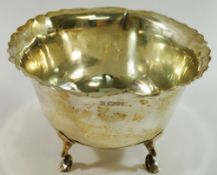 A silver bowl raised on four legs, Chester 1908, with wavy rim, 12.5cm diameter, 7.8cm high, 4.