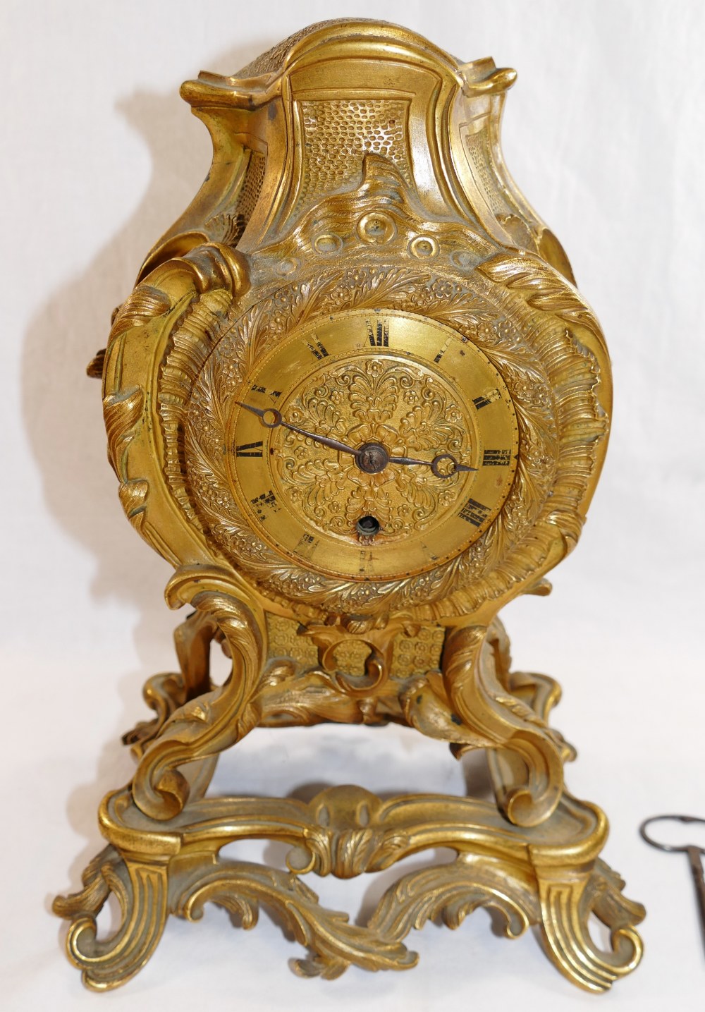 A 19th century gilt brass Rococo style mantle timepiece,