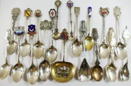 A collection of 23 sterling silver and other silver coloured metal souvenir spoons from across the