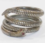 An early 20th century flexible sprung snake bracelet with red stone set eyes,