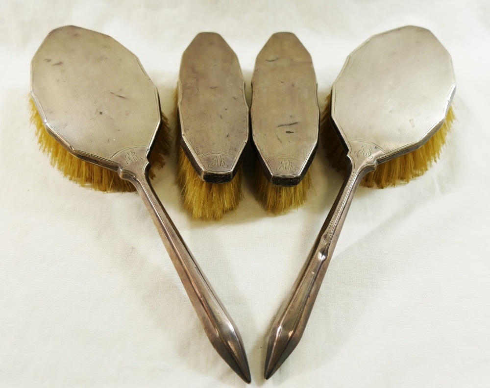 A pair of silver backed long handled hair brushes, with engine turned decoration, Birmingham 1935,