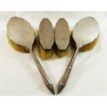 A pair of silver backed long handled hair brushes, with engine turned decoration, Birmingham 1935,