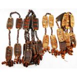 Eight tribal threaded lengths of carved gourd panels and seeds,