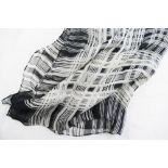 A Yves Saint Laurent black and white silk chiffon scarf with crossed thread pattern and YSL