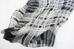 A Yves Saint Laurent black and white silk chiffon scarf with crossed thread pattern and YSL