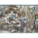 A large quantity of costume jewellery including vintage paste set items, silver, marcasite, ethnic,