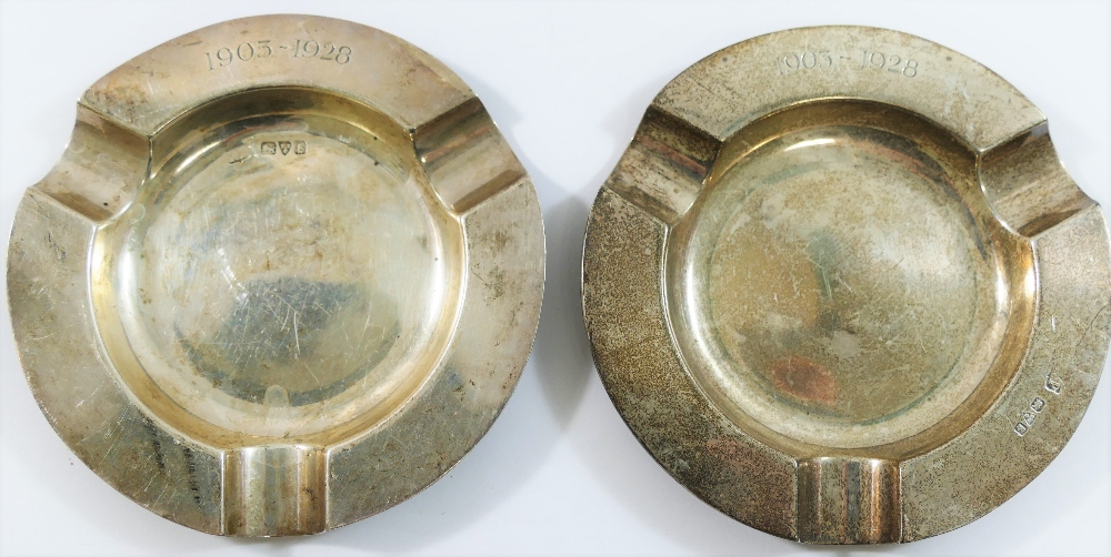 A pair of circular silver ashtrays, Chester 1927, inscribed with the dates 1903-1928, 10.