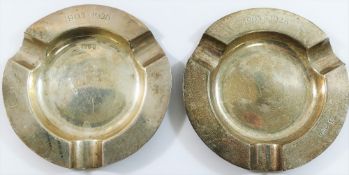 A pair of circular silver ashtrays, Chester 1927, inscribed with the dates 1903-1928, 10.