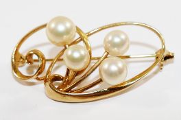 A Japanese Mikimoto yellow metal and cultured pearl brooch, stamped '14K', 3.7cm long, 5.
