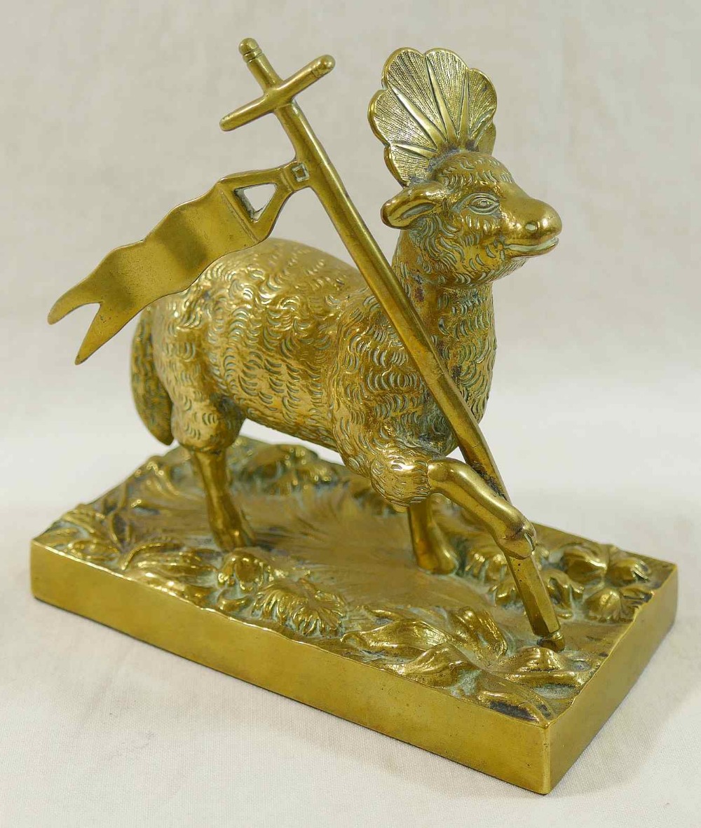 A brass figure of the Lamb of God on rectangular plinth,