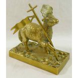 A brass figure of the Lamb of God on rectangular plinth,