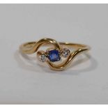 An early 20th century 18 carat gold sapphire and diamond cross over ring,