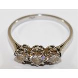 A platinum and diamond three stone ring, the round brilliant cut centre stone approximately 0.