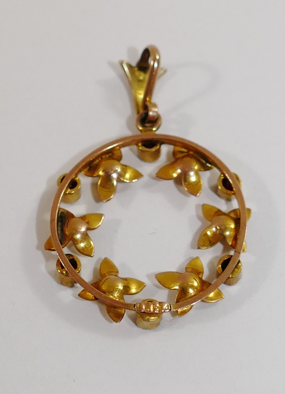 An early 20th century yellow metal circular pendant in the form of a wreath, - Image 2 of 2