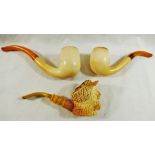 A Meerschaum pipe, the bowl carved with the head of a bearded man, laughing, wearing a hat,