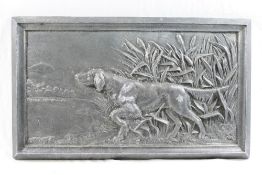 A patinated cast metal rectangular plaqu
