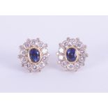 A pair 18ct yellow gold sapphire and diamond cluster earrings.