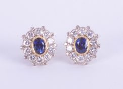 A pair 18ct yellow gold sapphire and diamond cluster earrings.