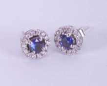 A pair 18ct white gold sapphire and diamond round stud earrings.