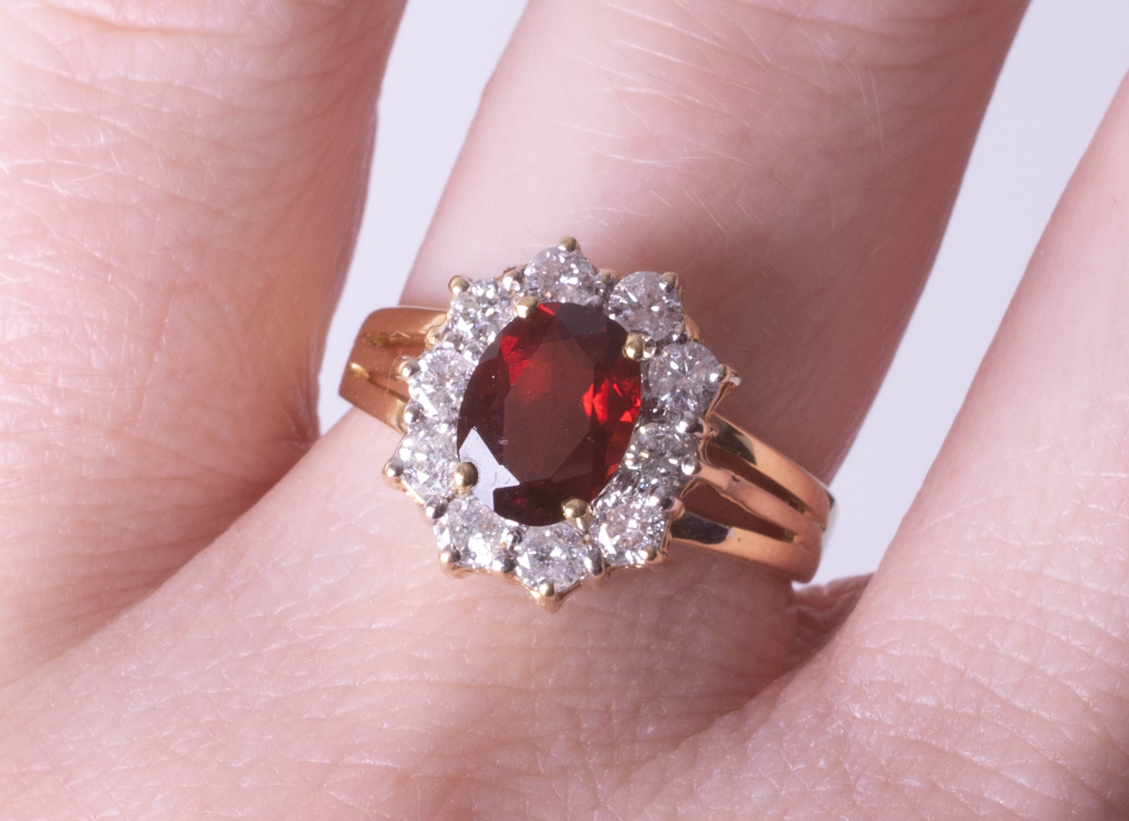 An 18ct diamond and garnet cluster ring, size M.