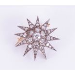 A Victorian twelve pointed diamond star pendant / brooch with silvered and gold back, set with forty