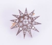 A Victorian twelve pointed diamond star pendant / brooch with silvered and gold back, set with forty