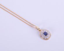 An 18ct yellow gold sapphire and diamond pendant.