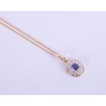 An 18ct yellow gold sapphire and diamond pendant.