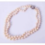 A double row pearl necklace with diamond set clasp.