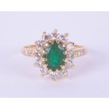 An 18ct yellow gold emerald and diamond oval cluster ring, size L.