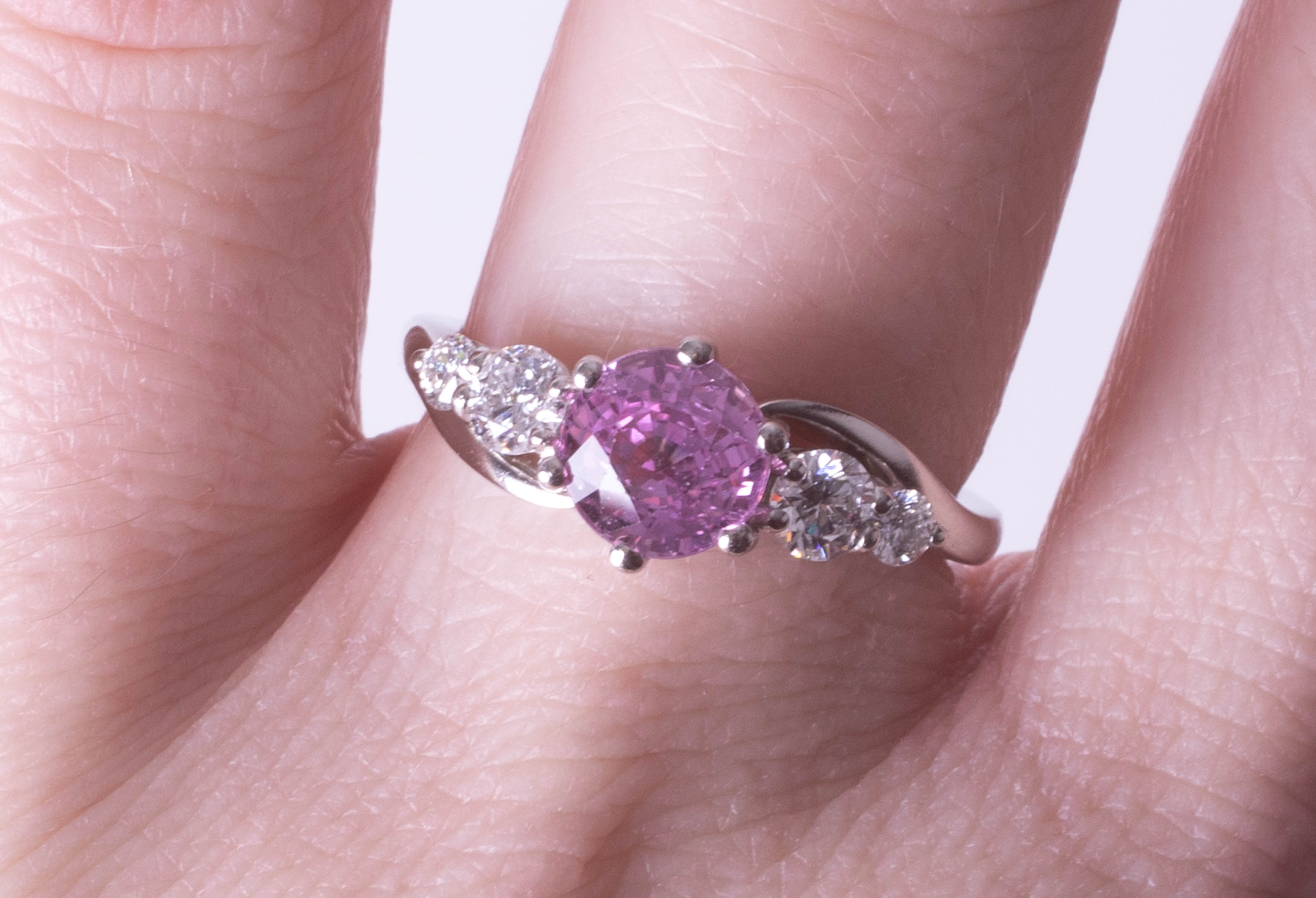 A platinum diamond and pink sapphire ring, size N.