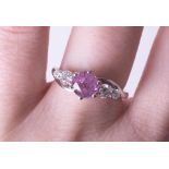 A platinum diamond and pink sapphire ring, size N.