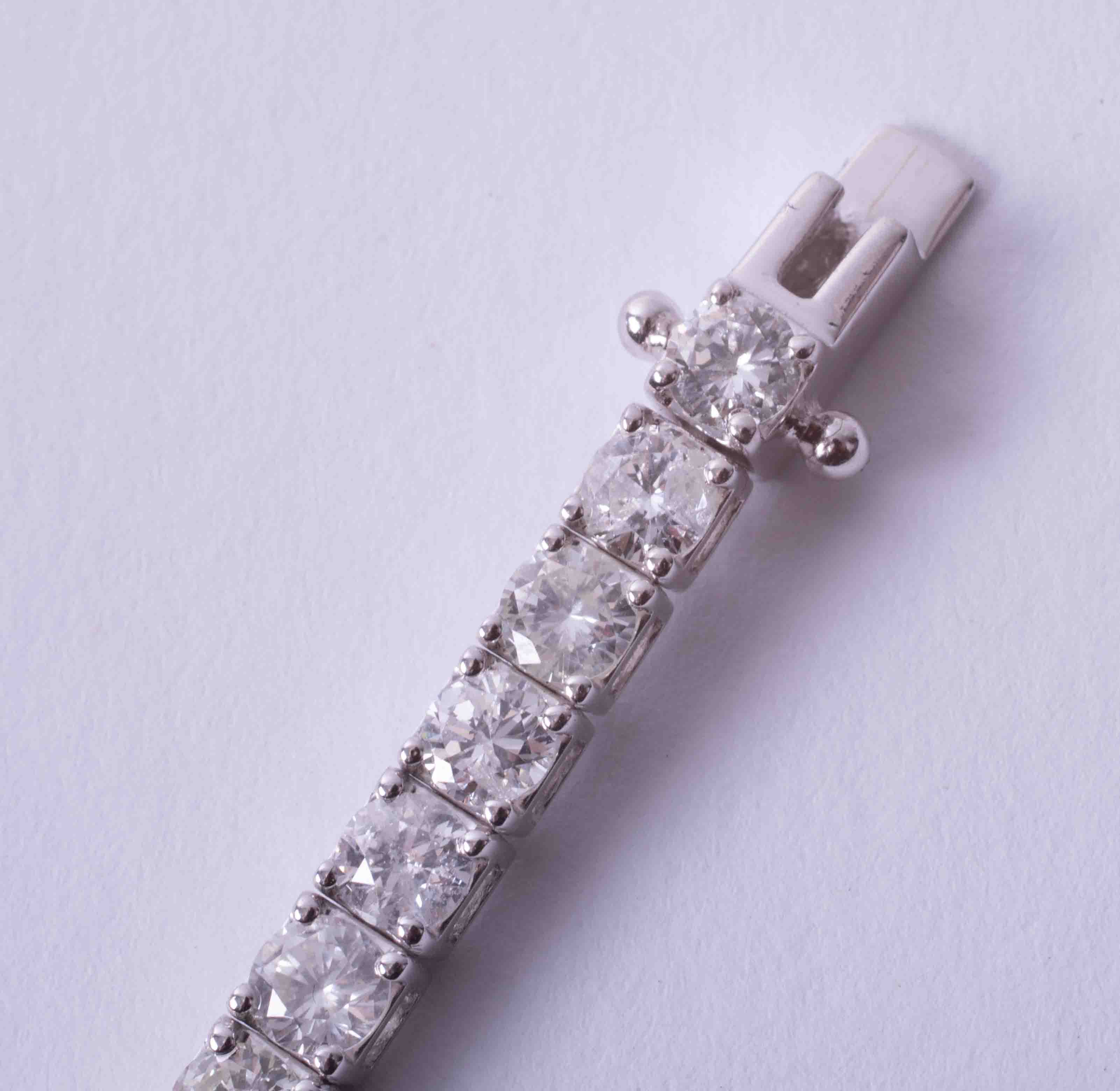 A fine 18ct white gold diamond line bracelet, total diamond weight approximately 8.20ct, set with - Image 7 of 9