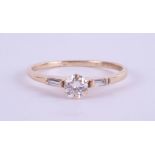 An 18ct yellow gold diamond ring set with further diamonds to the shoulders, approx. 0.50ct, ring