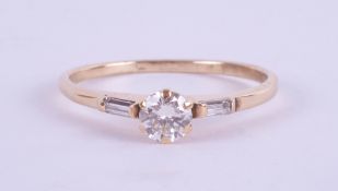 An 18ct yellow gold diamond ring set with further diamonds to the shoulders, approx. 0.50ct, ring