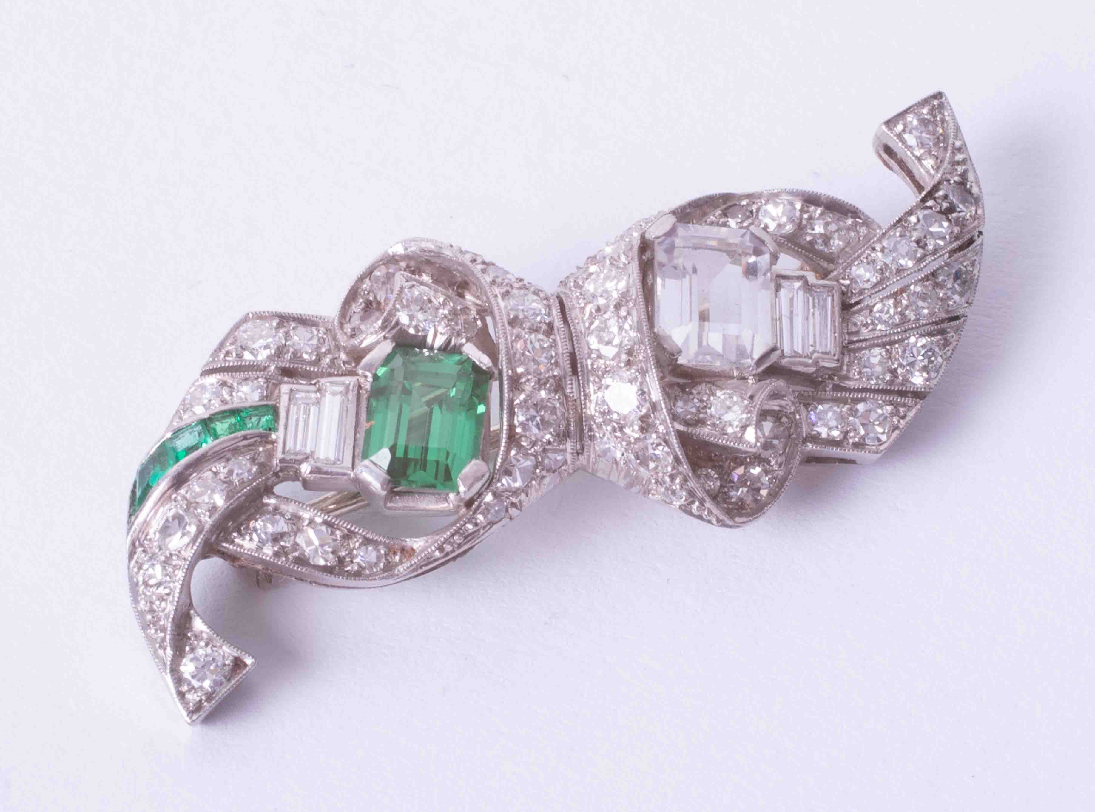 A diamond and emerald brooch set in platinum, (two main stones are paste).