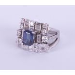 An 18ct white gold ornate dress ring set with a central rectangular sapphire and a mixture of