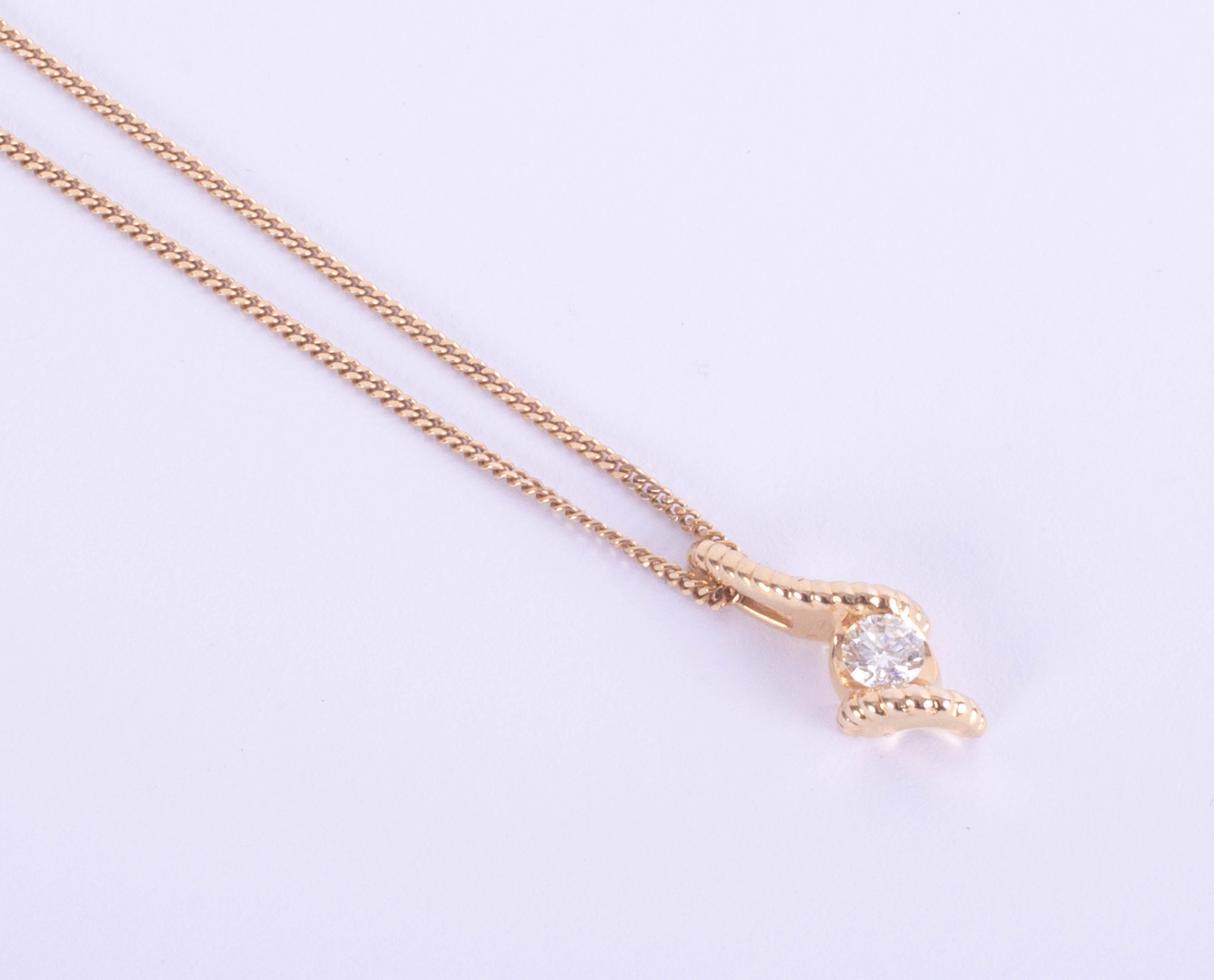 A modern 18ct yellow gold diamond pendant and chain.