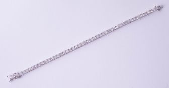 A fine 18ct white gold diamond line bracelet, total diamond weight approximately 8.20ct, set with