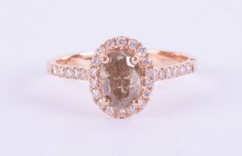 An 18ct rose gold champagne diamond halo set ring, approx. 1.10ct, ring size O.