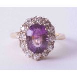 An 18ct yellow & white gold amethyst & diamond cluster ring, finger size L, no hallmarks.