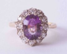 An 18ct yellow & white gold amethyst & diamond cluster ring, finger size L, no hallmarks.