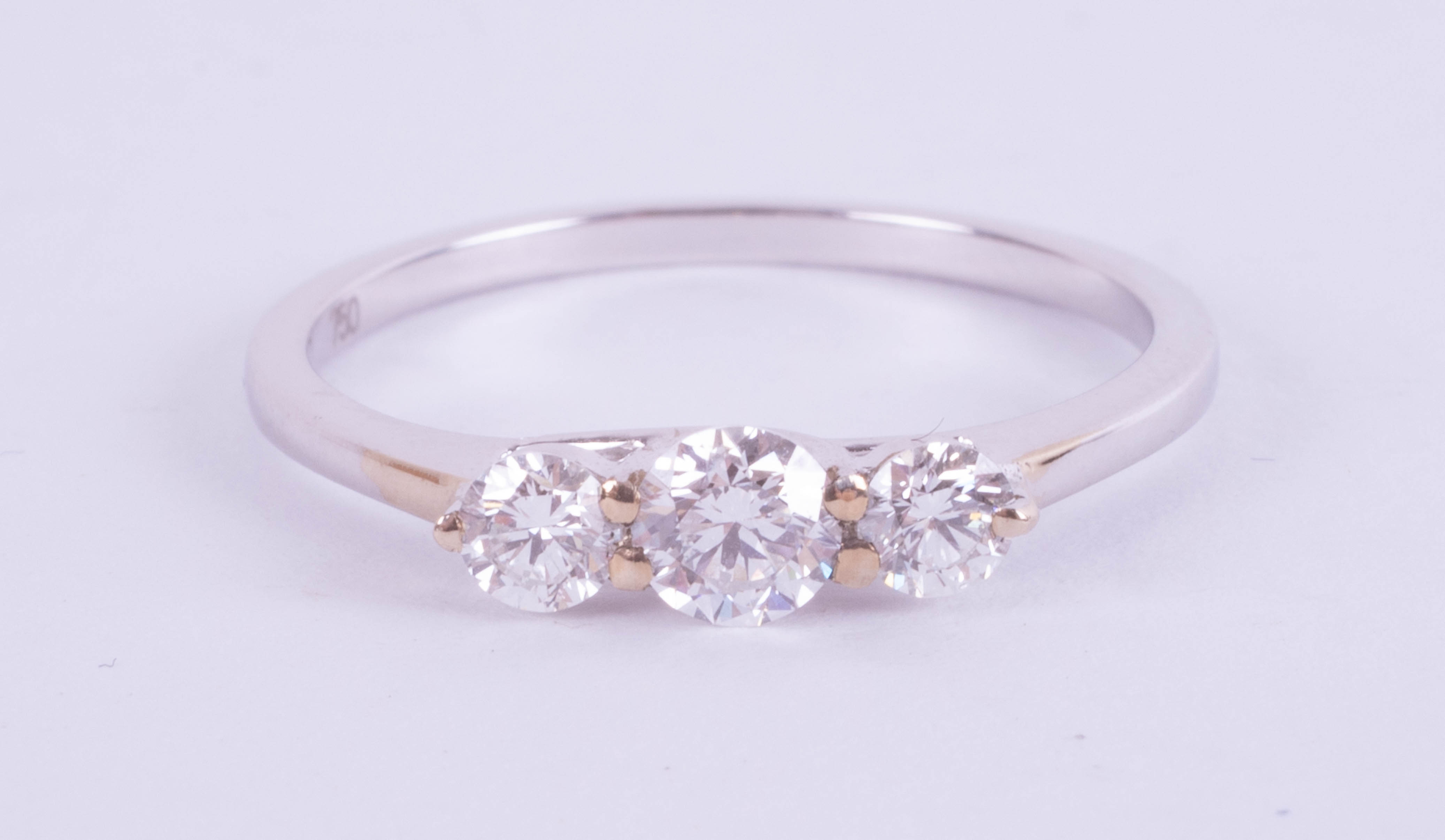 An 18ct white gold trilogy ring, approx. 0.50ct, estimated colour E, clarity SI1, ring size M.