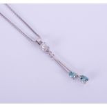 An 18ct white gold pendant set with enhanced blue and white diamonds, with chain.
