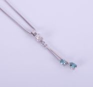 An 18ct white gold pendant set with enhanced blue and white diamonds, with chain.