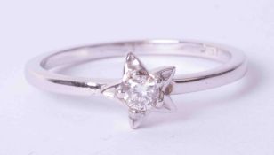 An 18ct white gold diamond single stone 'star' ring, size Q.