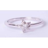 An 18ct white gold diamond single stone 'star' ring, size Q.